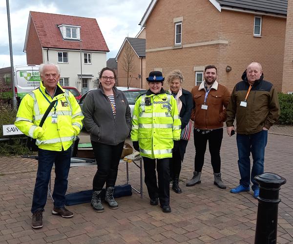 Eastlight staff, partners and local Police outdoors and smiling