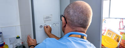 A person fixing a boiler
