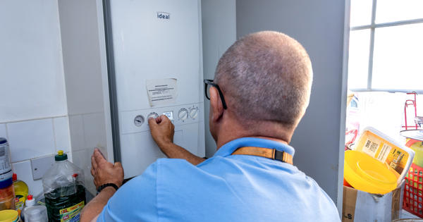A person fixing a boiler
