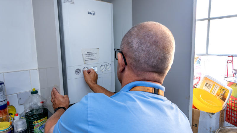 A person fixing a boiler