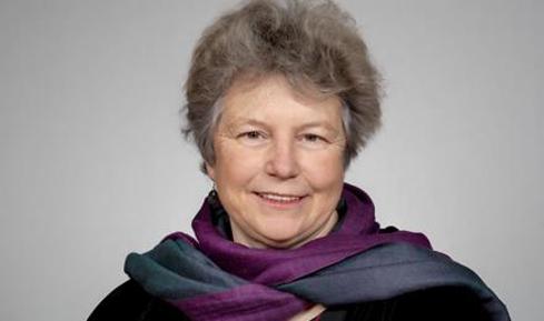A headshot of Hattie Llewellyn-Davies smiling.
