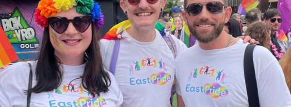 Three people from EastPride are stood together at Chelmsford Pride.