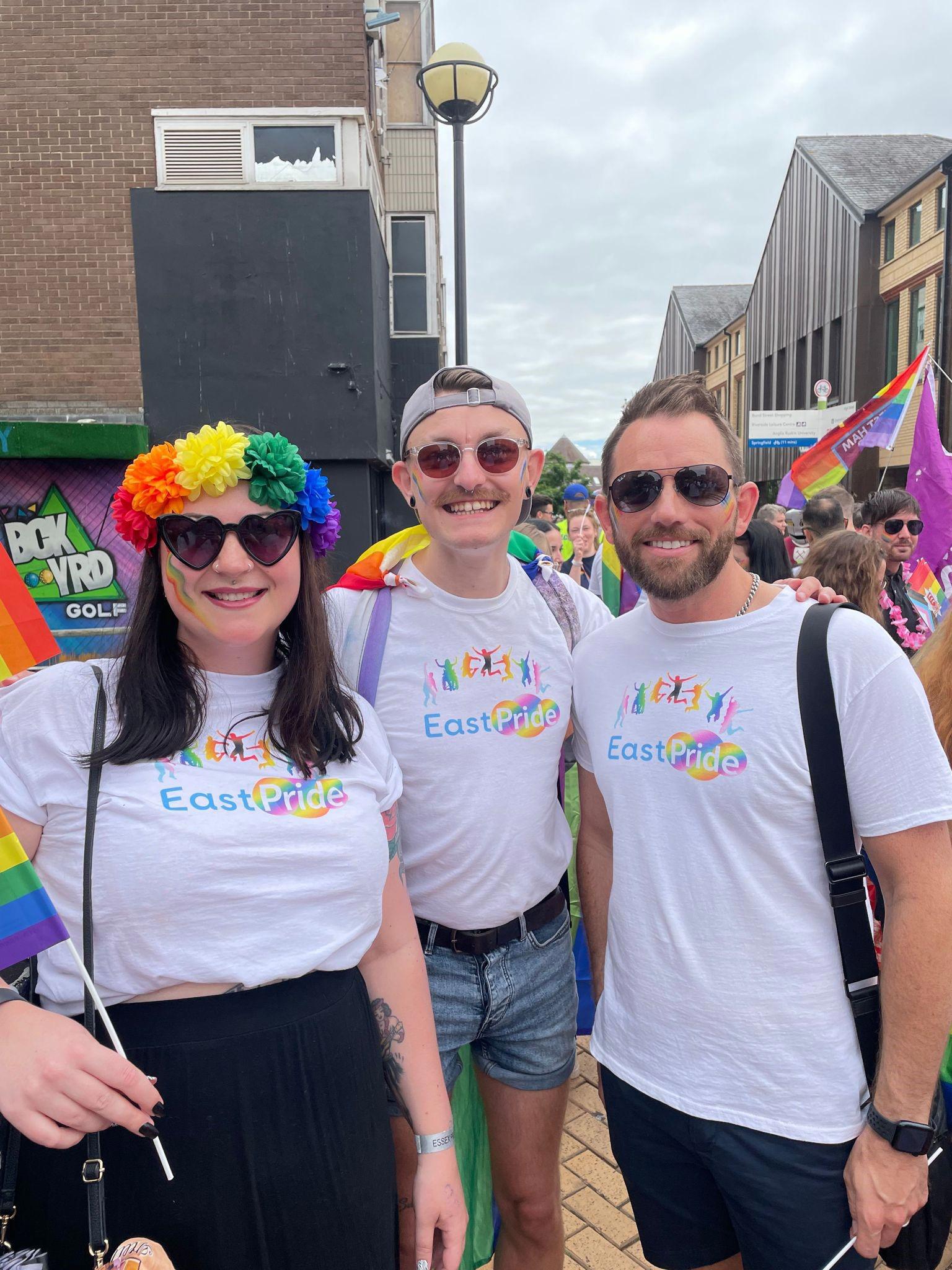 Three people from EastPride are stood together at Chelmsford Pride.