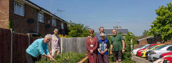 Eastlight's Bobby and Jo are stood with ERG Witham members who have installed a new flowerbed in their community.