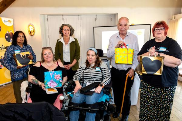 A group of residents, together with CIC Chair & Board member, Catherine Turner and Eastlight staff member Jo Barrett. The residents are holding their goodie bags, following the recognition ceremony/session. 