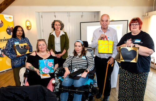 Residents holding their goodie bags following the Recognition session. They are standing together with Eastlight Leadership Team member, Jo Barret, and CIC Chair and Board member, Catherine Turner.