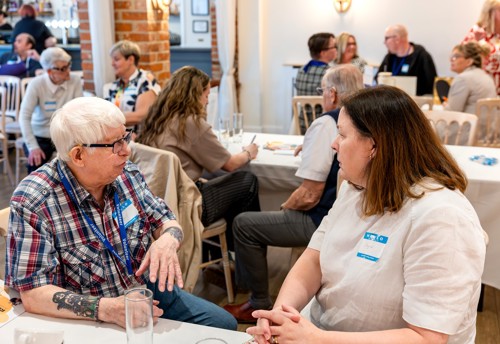 Eastlight staff members and residents discussing relevant issues during the 'carousel' session of the event.