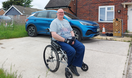 Craig Clackett, sitting proudly in his wheelchair, on his front drive.