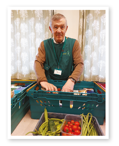 Barry with a crate of food at the foodbank