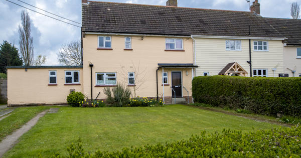 A semi-detached house painted a pale orange.