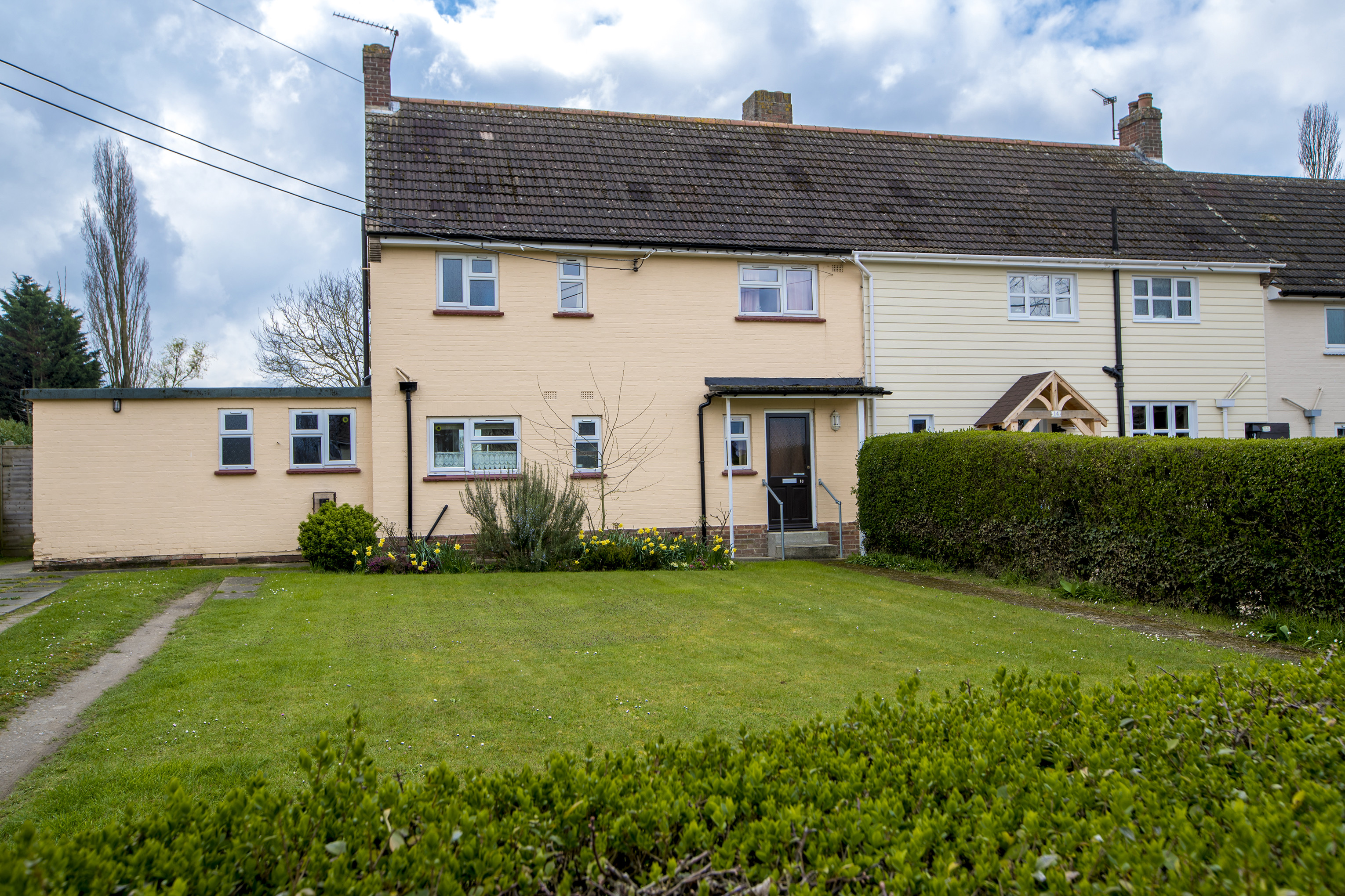 A semi-detached house painted a pale orange.