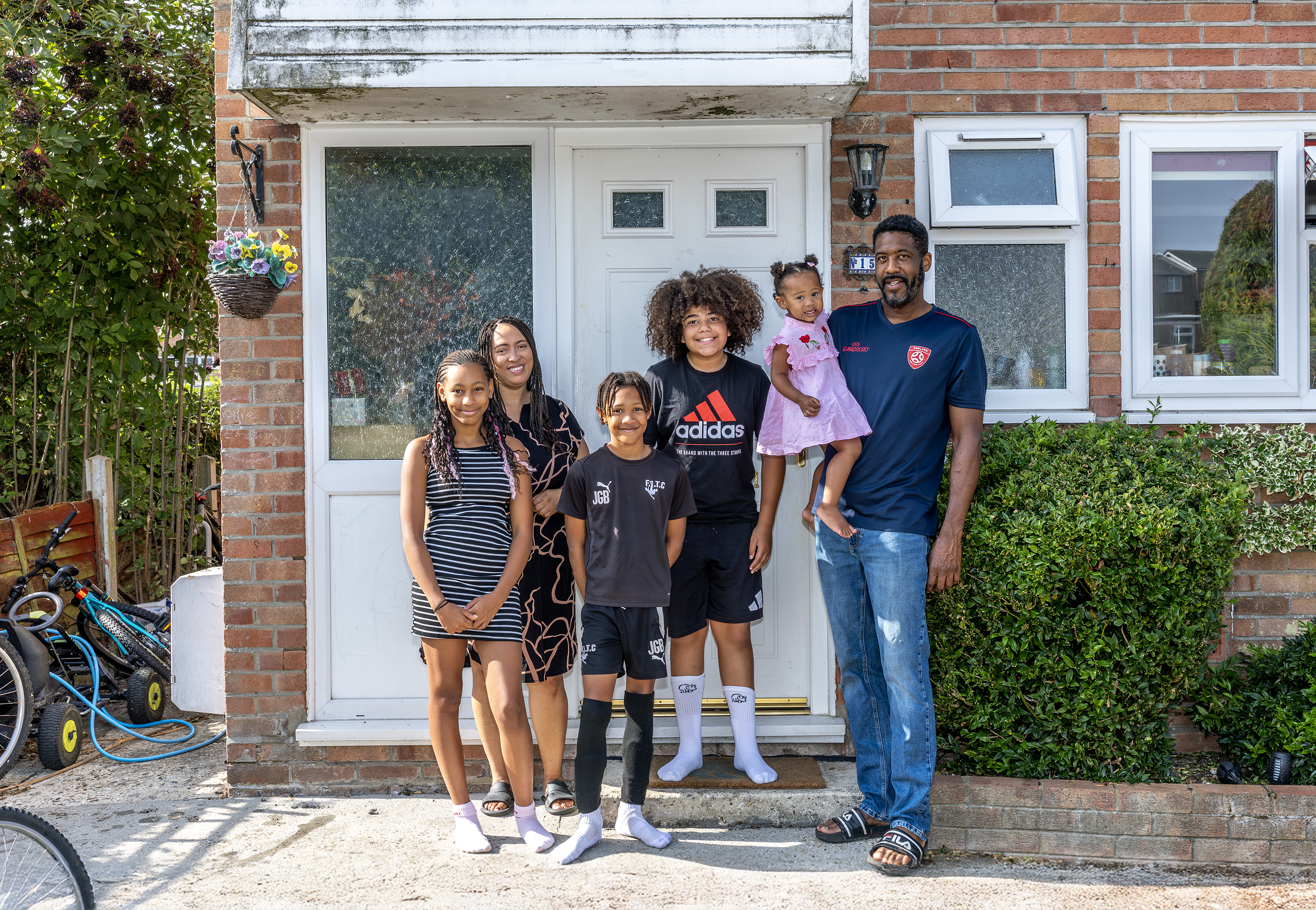 Eastlight resident Sheeren, her partner and four children are stood at the front of their house, in front of their front door.