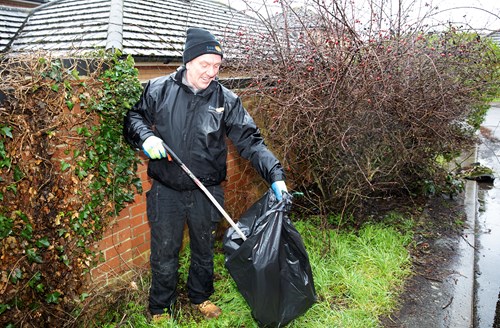 An Eastlight staff member picking up rubbish