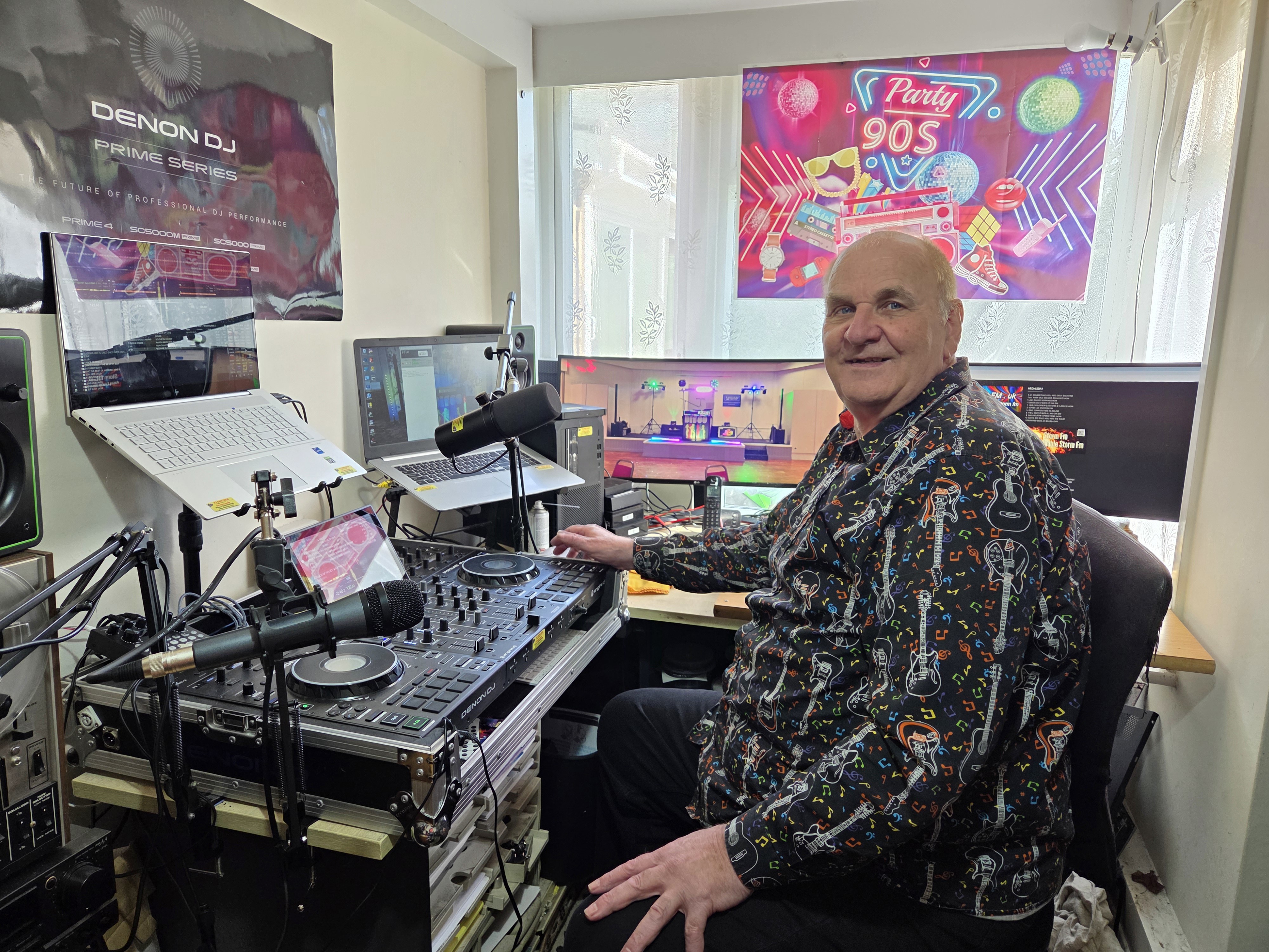Dave Leslie is sat in front of his DJ Decks that he uses for his radio show on Storm FM.