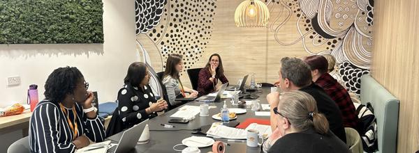 A group of residents and Eastlight staff members sat around a table.