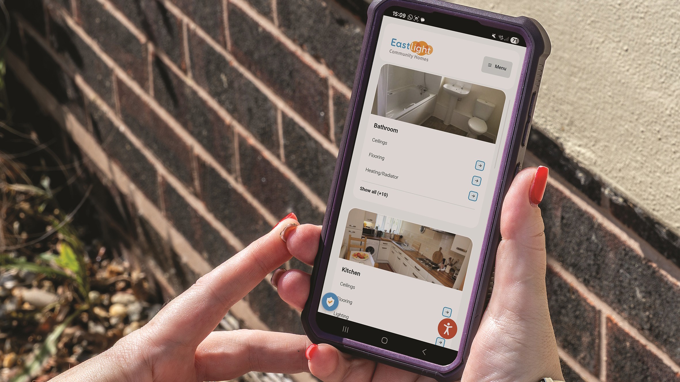 Two hands are holding a mobile phone which shows the My Eastlight portal.