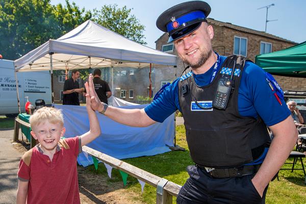 Police officer high fiving a child