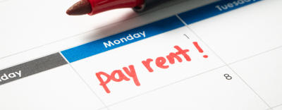 A calendar is open showing the first date on the month. Under the date, in red pen, says pay rent!