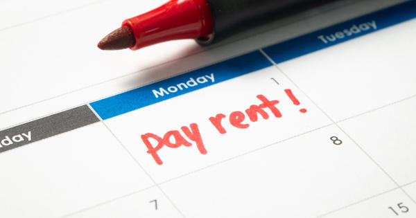 A calendar is open showing the first date on the month. Under the date, in red pen, says pay rent!