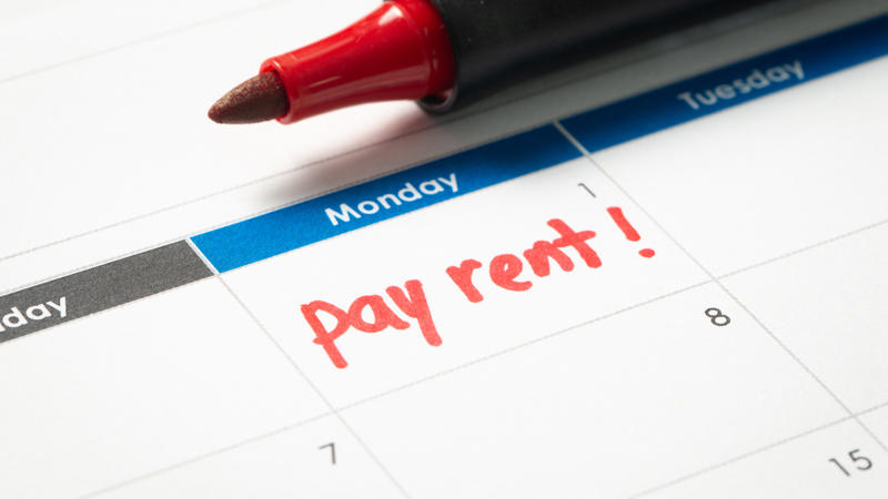 A calendar is open showing the first date on the month. Under the date, in red pen, says pay rent!