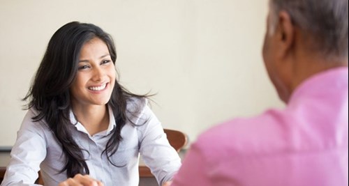 woman smiling and talking to man