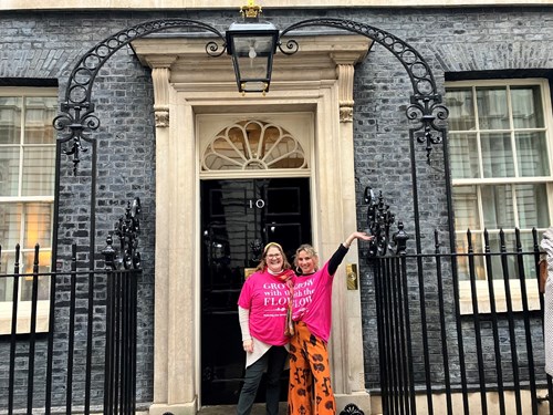 Suzanne Hunnable-Letch and Carolina Skoog outside Number 10 Downing Street wearing Grow with the Flow pink t-shirts to promote the All In initiative to support young girls in Halstead with their menstrual health.