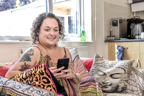 A person looking at their phone and smiling