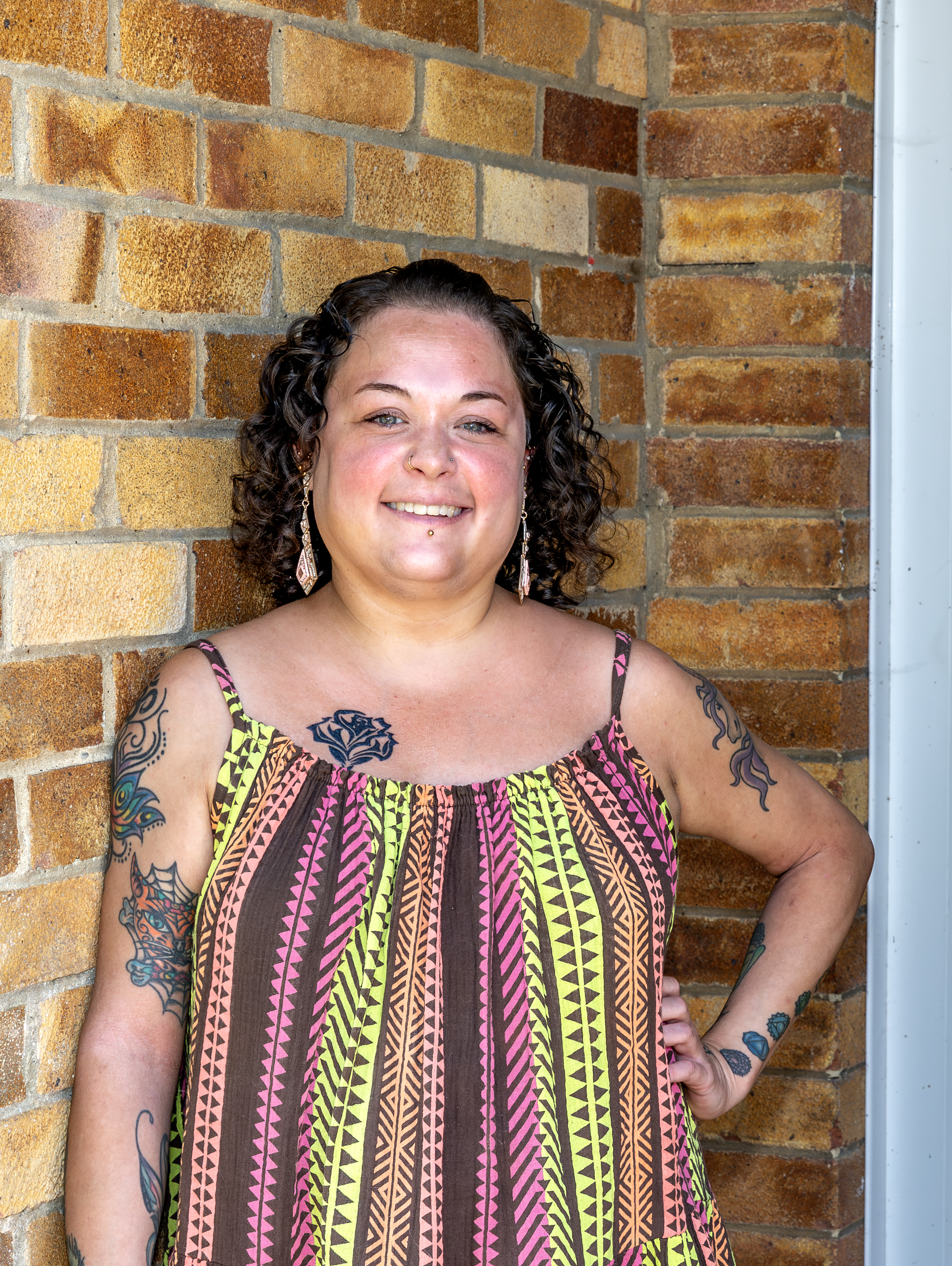 Young Eastlight resident Bobbie is stood against a brick wall with her hand on her hip.