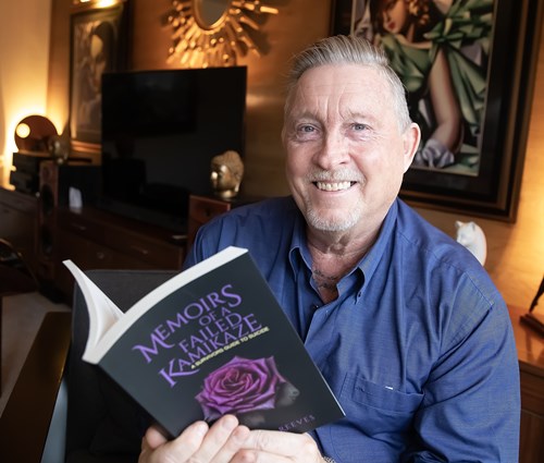 Martin Reeves holding his book and smiling