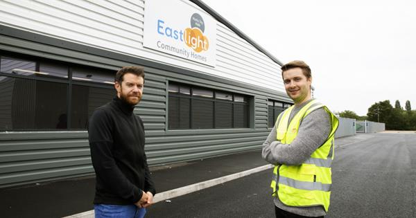 Two Eastlight employees at an Eastlight warehouse
